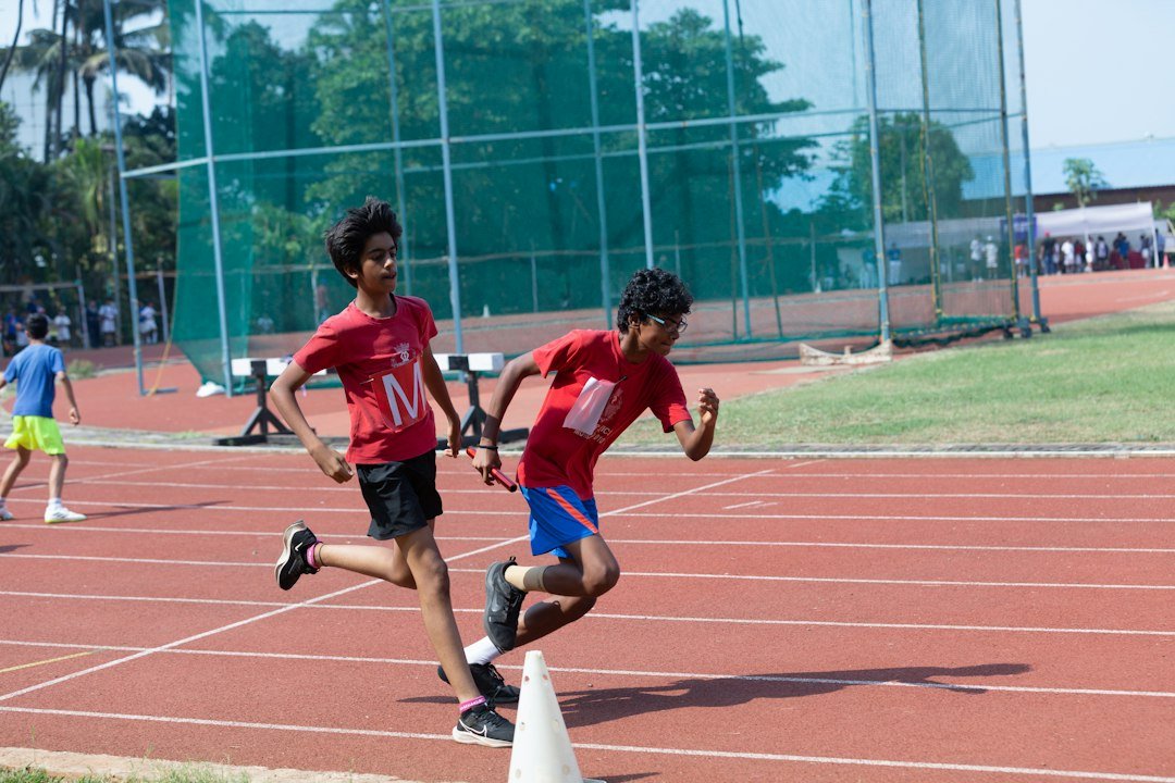 a-couple-of-kids-running-around-a-track-vyiyj-yijma